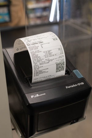 Moscow, Russia - 11 March 2022. Cash receipt in the payment terminal in the Perekrestok store