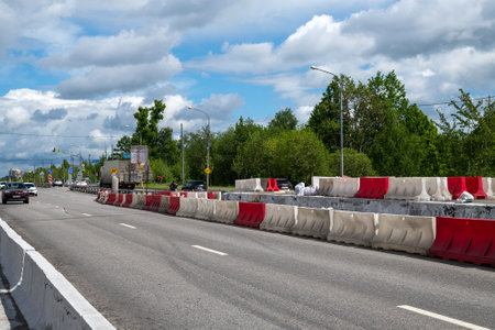 Moscow, Russia - June 04. 2022. Water-filled barriers stand along the road during repairs.のeditorial素材