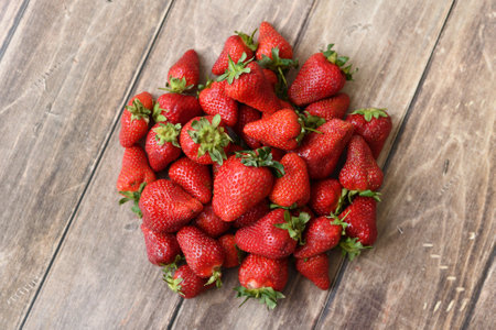 Ripe strawberries on wooden backgroundの写真素材