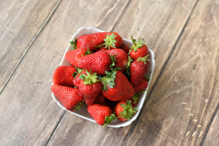 Ripe strawberries on wooden backgroundの写真素材