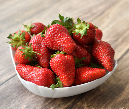 Ripe strawberries on wooden backgroundの写真素材