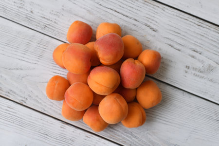 Ripe apricot on wooden backgroundの写真素材
