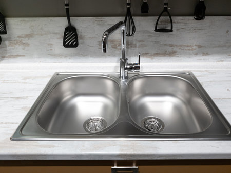 Two sinks and faucet in the kitchenの写真素材