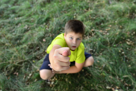 Teen boy shows the hand gesture.の写真素材