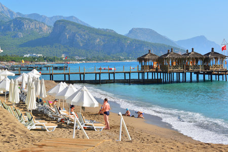 Kemer, Turkey - 06. 21.2014. People on the beach with a pierの写真素材