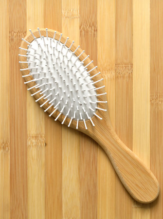 Wooden comb on wooden background - an ecological conceptの写真素材