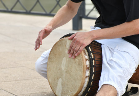 A man plays the djembe drum on street in Moscow, Russiaの写真素材