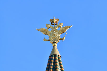 Double-headed eagle - coat of arms of the Russian Federation on the spire of the Resurrection Gate in the Kremlin in Moscow, Russiaの写真素材