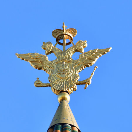 Double-headed eagle - coat of arms of the Russian Federation on the spire of the Resurrection Gate in the Kremlin in Moscow, Russiaの写真素材