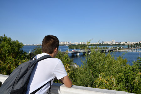 Young man on the embankment of the Dnieper river in Kiev, Ukraineの写真素材