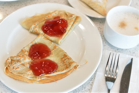Breakfast - pancakes with jam and a coffeeの写真素材