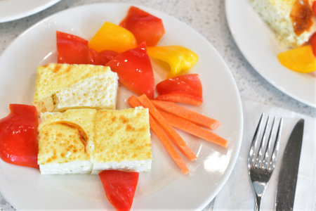 Breakfast - scrambled eggs and fresh carrots and the bell peppersの写真素材