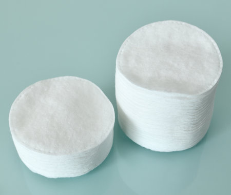 Stack of Cotton disks on a light blue backgroundの写真素材
