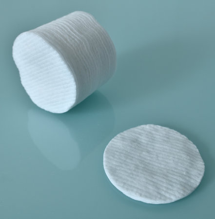 Stack of Cotton disks on a light blue backgroundの写真素材