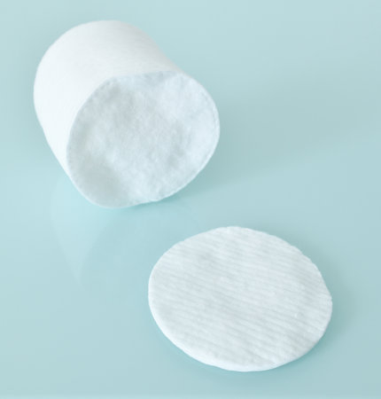 Stack of Cotton disks on a light blue backgroundの写真素材