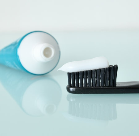 Toothbrush and toothpaste on light blue backgroundの写真素材