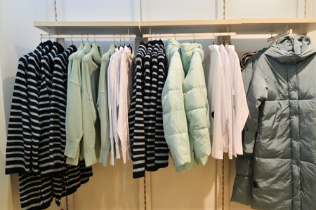 Women's clothing hanging on a hanger in storeの写真素材