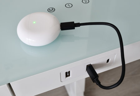 Box for wireless headphones is charged from USB tableの写真素材
