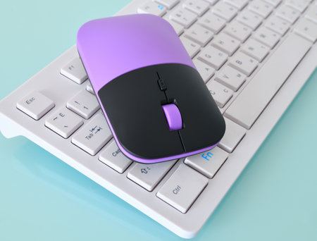 Computer mouse and the white keyboard fragmentの写真素材