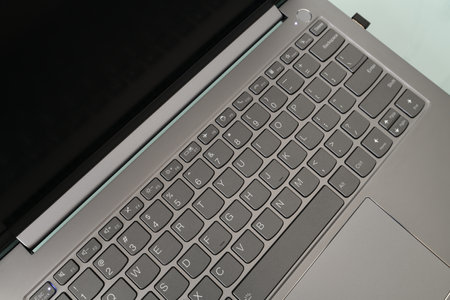 Keyboard of open laptop with the screen turned offの写真素材