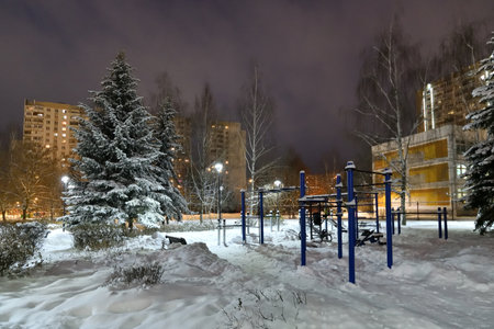 Winter cityscape with multi-storey residential buildings and snow covered fir trees in Moscow, Russiaの写真素材