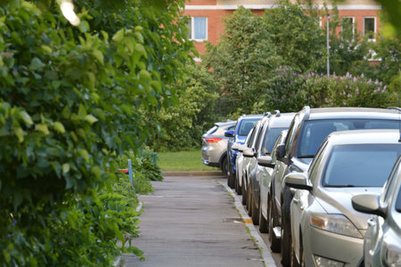 Moscow, Russia. Row of cars parked along sidewalk near houseの写真素材