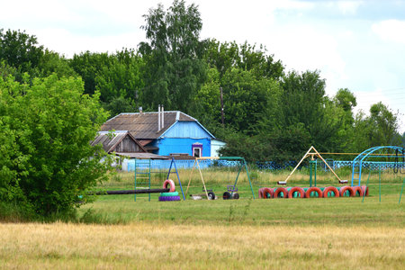 Rural house with homemade children's playground made from tires, Russiaの写真素材