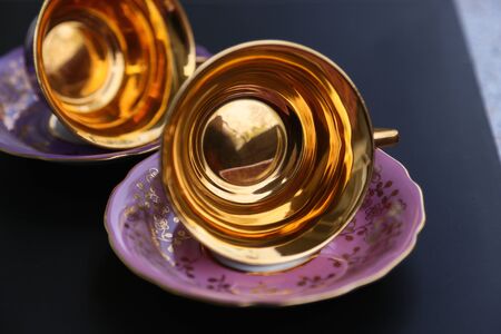 Porcelain lilac cup for tea with a gold coverの写真素材