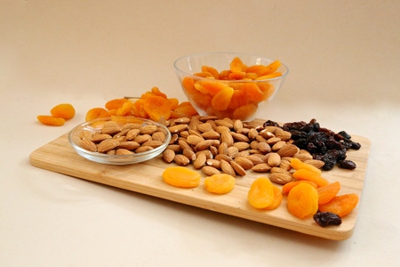dry apricots, nuts and dry black grapes on a wooden dostochka - it is tasty and beautiful, fruit a still life fruit still lifeの写真素材