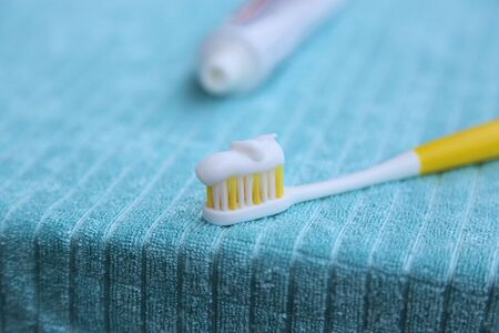 white tooth paste on the yellow tooth brushの写真素材