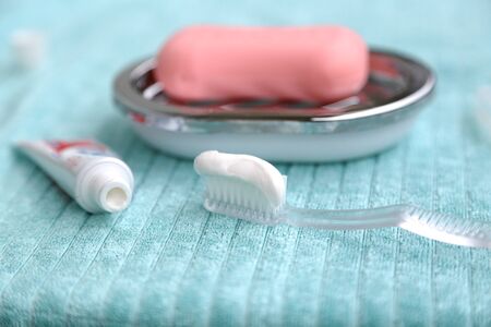 pink soap and white paste on the tooth brush to clean the teethの写真素材