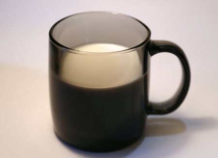 White cold milk in a dark-colored cup of dark glassの写真素材