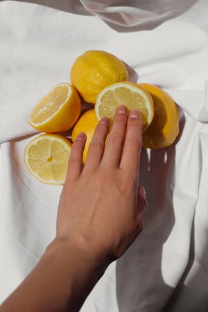Fresh lemon and lemon peel on white background. Fresh ripe lemons. Half of ripe lemon.の写真素材