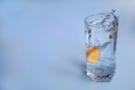 A splash of water in a glass due to a fallen lemonの写真素材