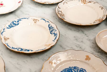 Set of vintage plates on a marbel tableの写真素材