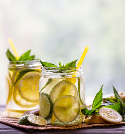 Two jars with cold lemonade on the tableの写真素材