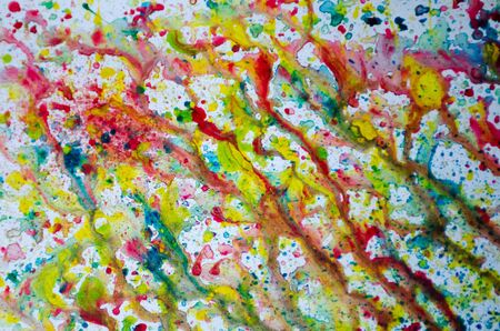 Abstract art of vivid bright colorful watercolor splash and drops on the white paper. Whimsical childish technique for creativity and inspiration for kids and adults.の写真素材