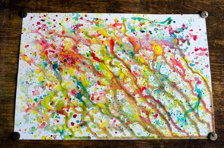 Abstract art of vivid bright colorful watercolor splash and drops on the white paper. Whimsical childish technique for creativity and inspiration for kids and adults.の写真素材