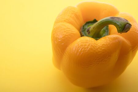 Old pepper, spoiled food. On a yellow background. The passage of time, passing away. I'm not...