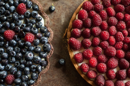 Cake with raspberries and blueberries on a metal backgroundの写真素材