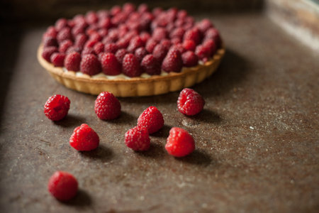 Raspberry tart with fresh raspberries on a rustic background
