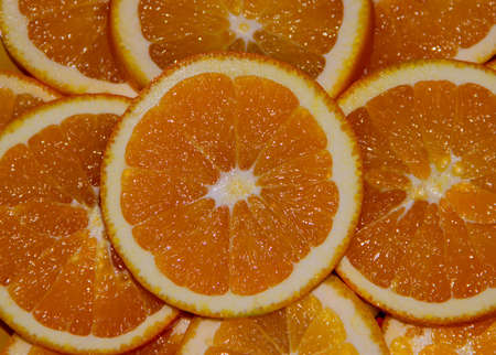 Background juicy slices of oranges - the concept of food