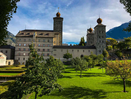 Sunny day with blue sky in the mountains with magnificent views of the Alps and castle Stockalper in Brig, Switzerlandのeditorial素材