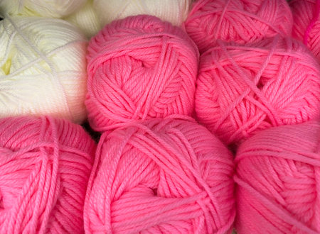 Balls of wool pink and white colors. The concept is a hobby - knitting. Fun doing handmadeの写真素材