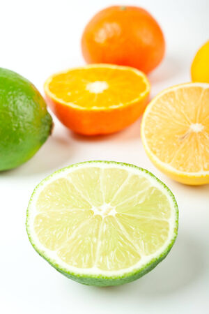 group of whole and cut in halves limes, tangerines and lemonsの写真素材