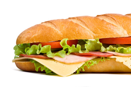 half of long baguette sandwich with lettuce, tomatoes, ham, turkey breast and cheeseの写真素材