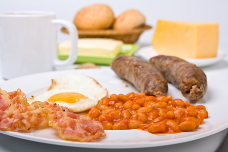 traditional english breakfast - egg, sausages, beans , bacon and coffeeの写真素材