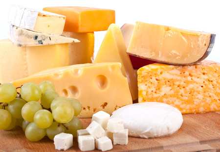 big group of cheeses with white grapesの写真素材