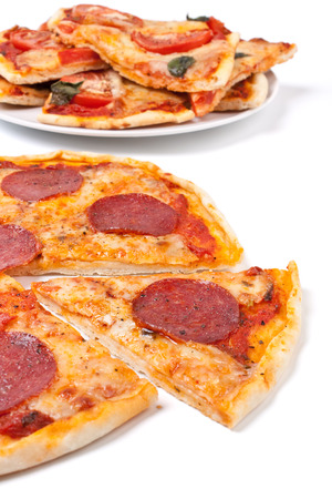 sliced pepperonii pizza on white backgroundの写真素材