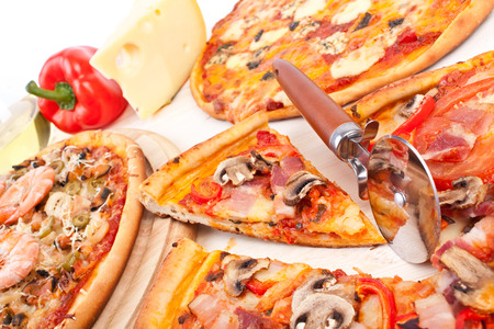different pizzas on a tableの写真素材